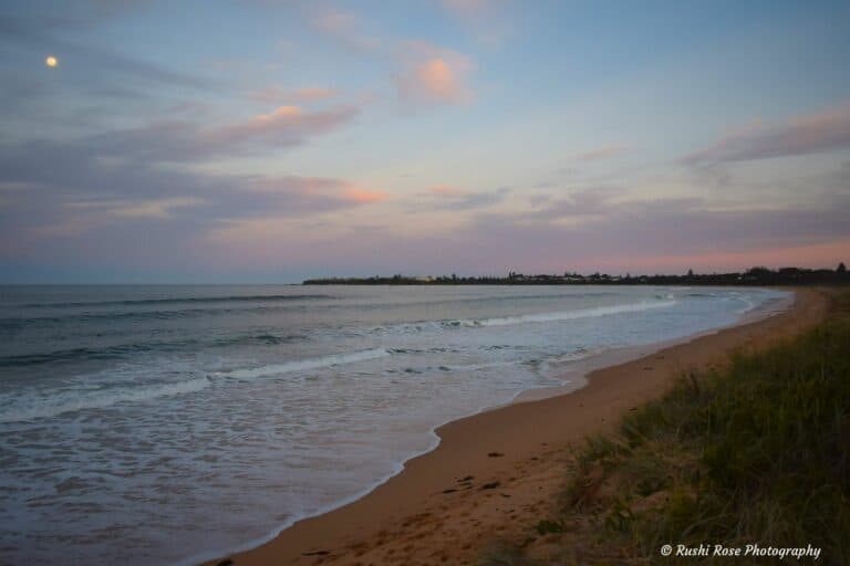 Beautiful sunset with the moon and view of Tilbury Cover from the main beach at Culburra Beach South Coast NSW.