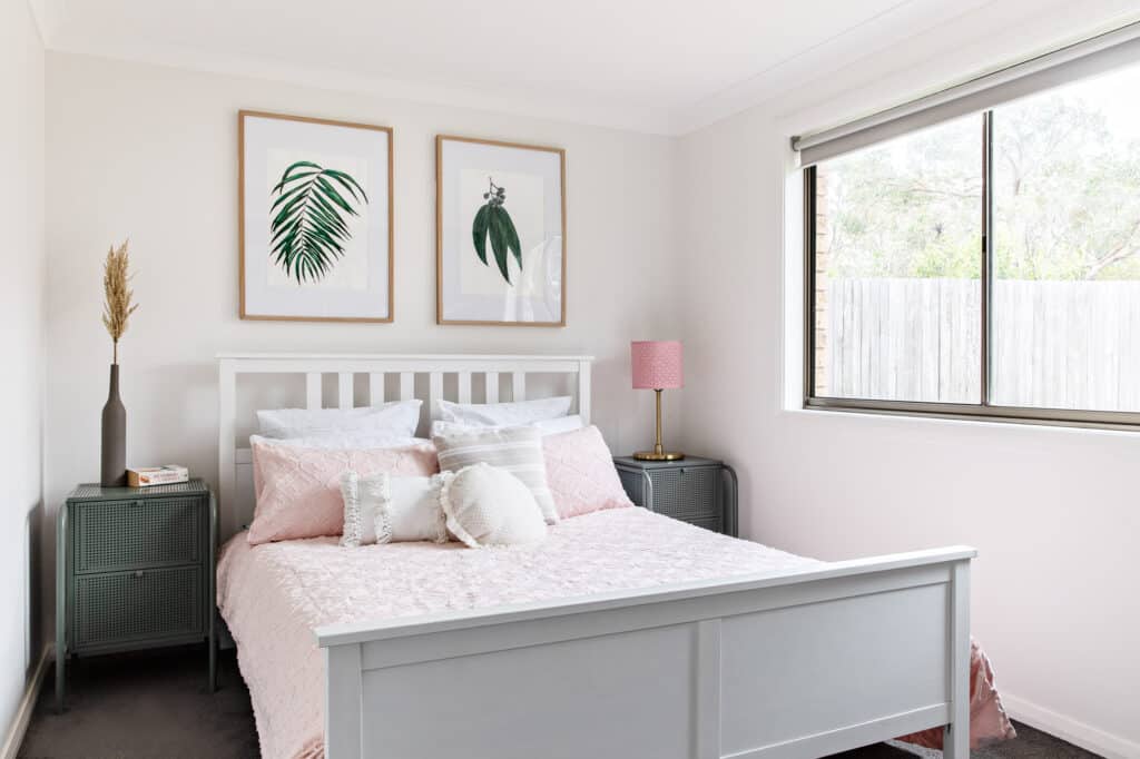 Downstairs queen bedroom with queen size bed with views of the rear bushy yard at Silvermere Coastal Retreat Culburra Beach South Coast NSW.