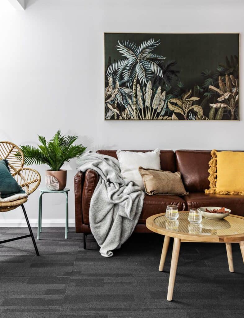 Image of the zen room located in Silvermere Coastal Retreat Culburra Beach South Coast NSW. In the zen room is a lounge and an armchairs where guests can meditate in silence or have an area which can unwind from being to stimulated people.