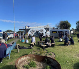 Franks Coffee Van is located in Culburra Beach on South Coast NSW. People sitting and lying around on the grass enjoying the sun and having a coffee.