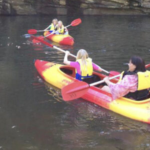 A mum and her daughters using kayaks in Kangaroo Valley river. They hired them from Kangaroo Valley Kayaks.